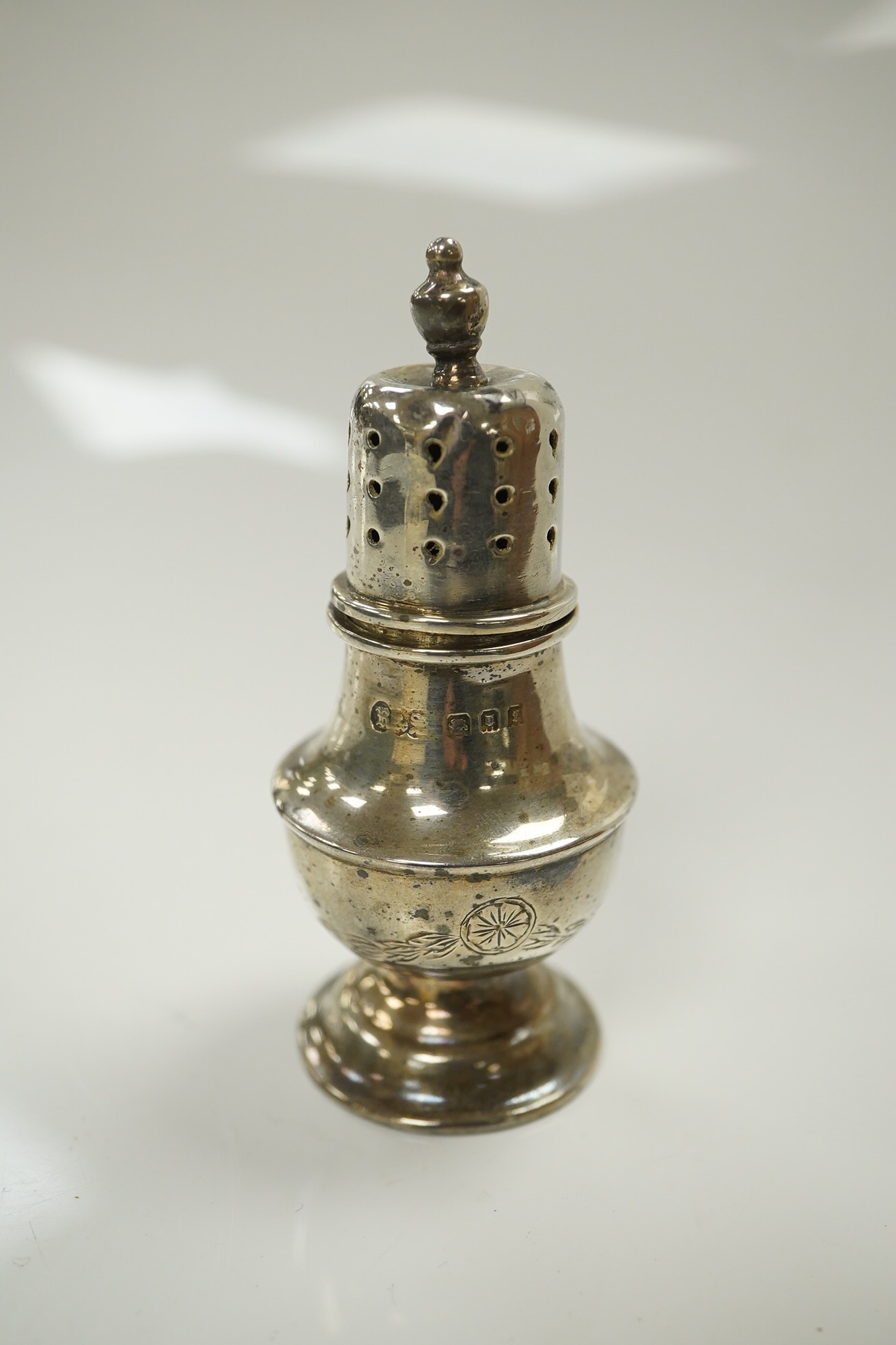 A group of assorted small silver wares including two vesta cases and two napkin rings, 5oz. of weighable silver, a mother of pearl handled butter knife, three pepperettes and a 19th century silver keywind fob watch. Cond